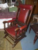 A maroon Rexine upholstered, satinwood framed American design Rocking Chair.