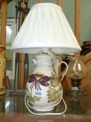 A Moorcroft table lamp in Columbine pattern, 15" tall including shade.
