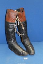 A pair of "black & tan" hunting Boots, possibly size 9, (display only), and a pair of spurs.