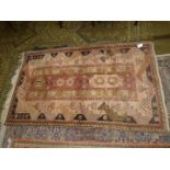 A hearth rug with central panel of stylised flowers, border with zig- zags in mustard,