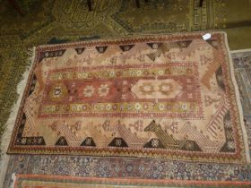 A hearth rug with central panel of stylised flowers, border with zig- zags in mustard,