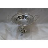 An Aspreys Arts & Crafts Silver Tazza with wide deep loop handles standing on circular step base