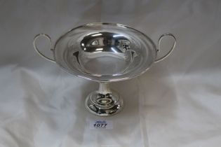 An Aspreys Arts & Crafts Silver Tazza with wide deep loop handles standing on circular step base