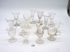 A quantity of old toasting glasses, some with baluster stems,