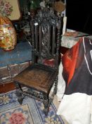 A dark Oak hall Chair having a solid seat,