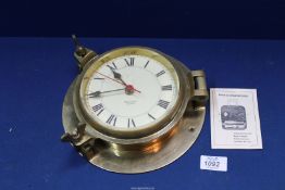 A Nauticalia quartz movement, brass cased Porthole bulkhead mounting clock.