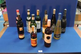 Twelve bottles of alcohol including; Canyon Creek merlot, Dry Martinie, German Langenback, Cava,