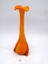 A tall vintage orange Art glass vase having slender neck and rib decoration, 15" tall.