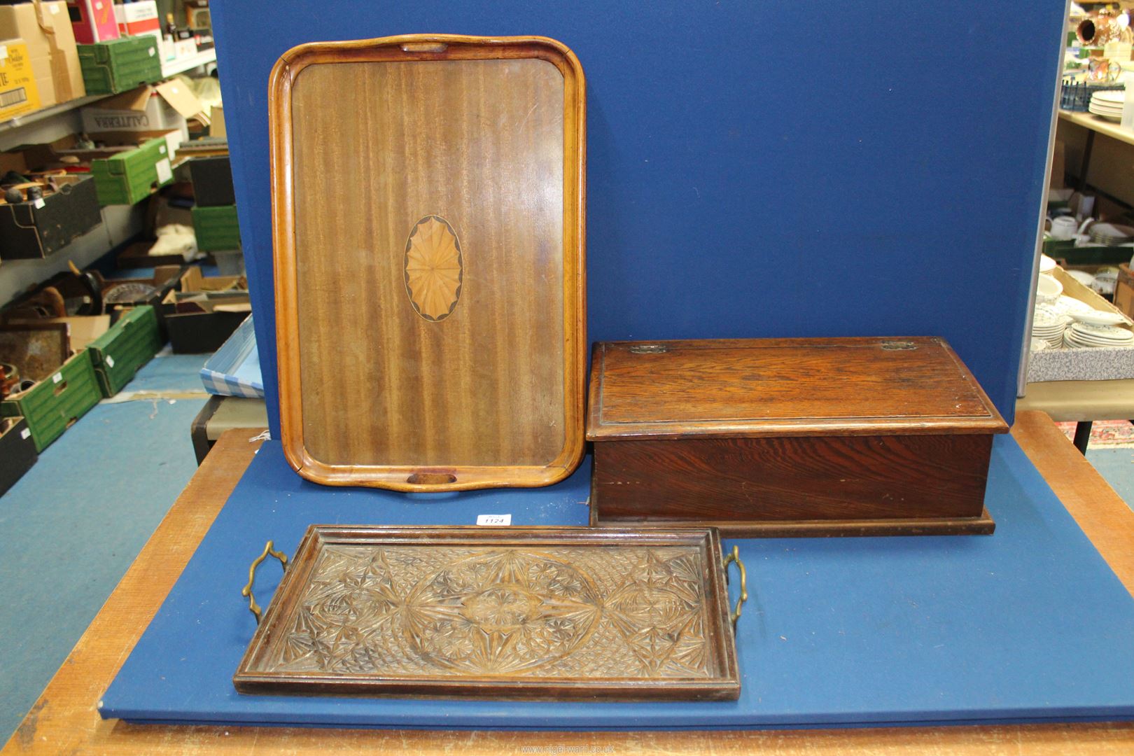 Two trays, one with carved detail and brass handles,