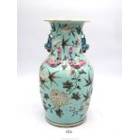 A large turquoise blue glazed Oriental vase having applied dragon and lizard decoration with floral