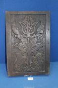 An Oak wall/furniture panel carved with stylised flower, 12" x 17".