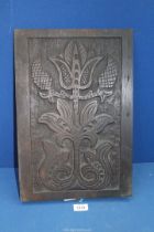 An Oak wall/furniture panel carved with stylised flower, 12" x 17".