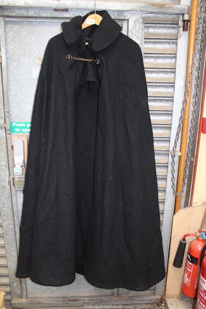 A large black woolen Cloak, possibly clerical, having mask lion button and chain fastening,