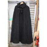 A large black woolen Cloak, possibly clerical, having mask lion button and chain fastening,