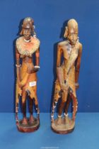 A pair of carved Tribal figures, some beading missing, 23 1/2" tall.
