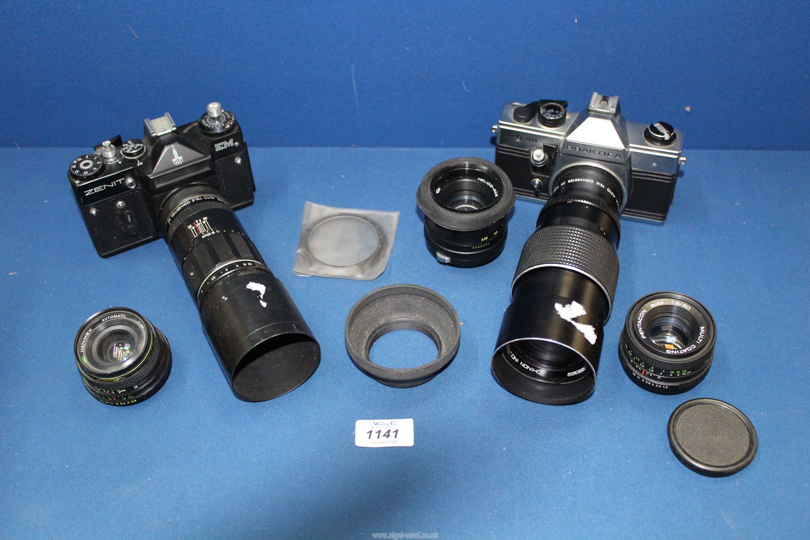 Two cameras including Zenit EM with Helios Auto tele Converter and Praktica MTL50 camera plus
