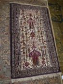 A border patterned and fringed rug in dark red on beige ground with jewel colours, 55'' x 28''.