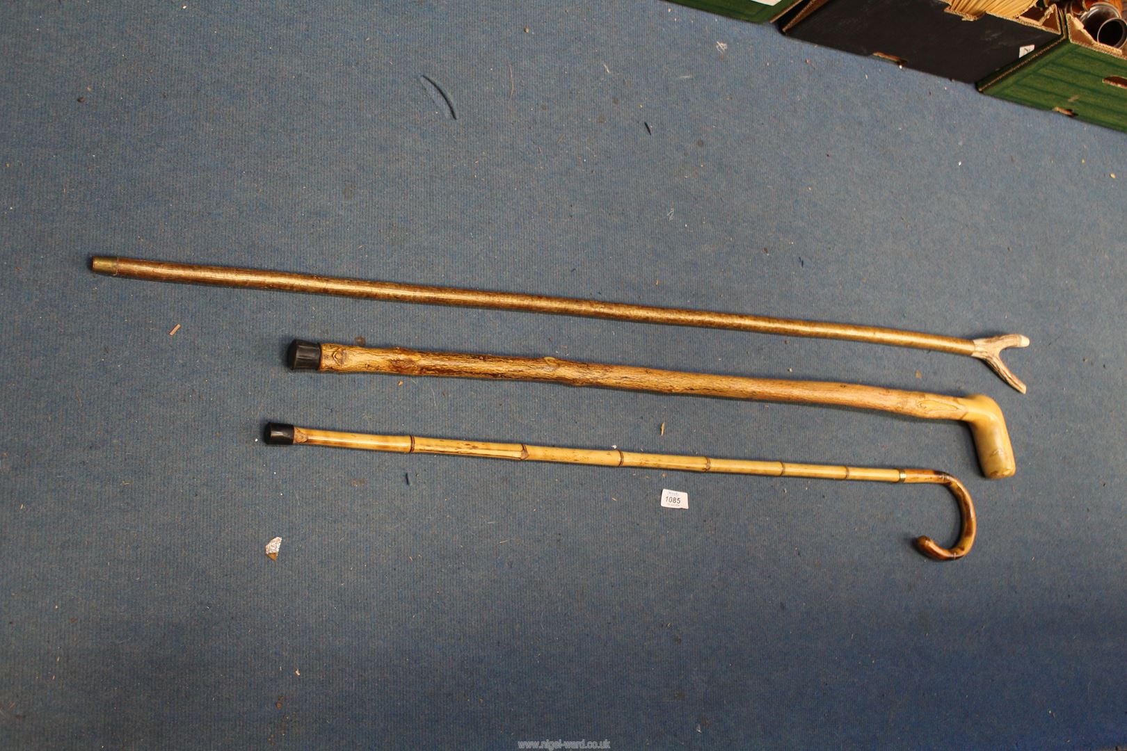 Three walking sticks: one an Antler handled thumb stick with whistle feature.