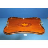 A 19th century Mahogany serpentine shape Butlers Tray with satinwood vase oval inlay to centre and