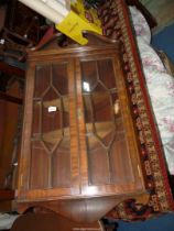 A Mahogany wall hanging corner display cabinet having a pair of opposing seven pane glazed doors