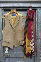 A Gieves & Hawkes camel coloured waistcoat with gold lining plus a small quantity of ties,