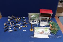 A quantity of mostly Britains zoo animals and hand-made zoo buildings (a/f).