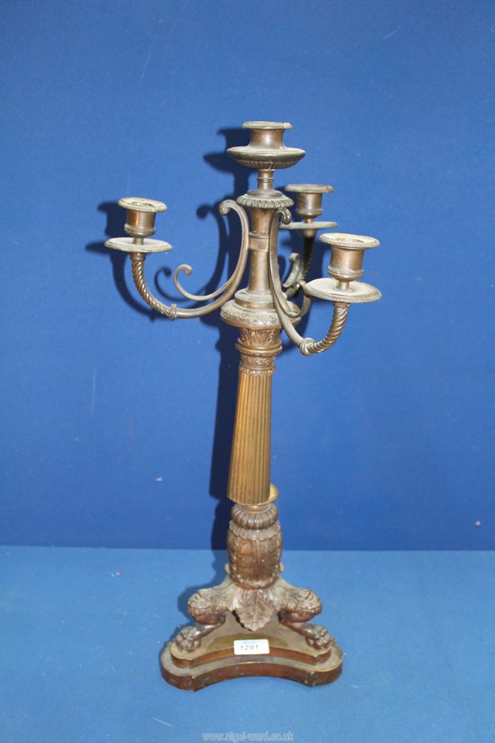 A heavy bronze metal four light Candelabrum having a tapering reeded column, swept sconce supports,