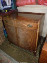 A Mahogany bow fronted Cabinet having a pair of opposing doors with oval Boxwood stringing,