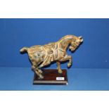 A heavy cast figure of a Chinese Tang horse on wooden plinth, 12" long x 10" tall.