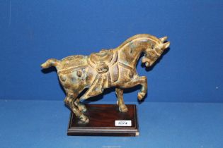 A heavy cast figure of a Chinese Tang horse on wooden plinth, 12" long x 10" tall.