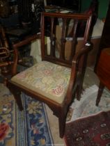 An elegant Georgian Mahogany open armed carver/elbow Chair having stylised floral bosses to the