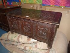 A compact Oak three panelled carved Blanket Chest, 36'' x 18 1/4'' x 18'' high.