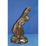 A heavy cast Bronze figure of a female peasant carrying firewood on her back, signed T.