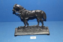 A black cast metal doorstop in the form of a horse, 9 1/4" high.
