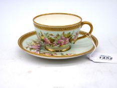 A delicate Royal Worcester porcelain cabinet cup and saucer painted with pink flowers with gilt