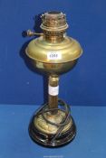 A brass oil lamp, partly converted to electric having an Art Nouveau base, 18" tall.