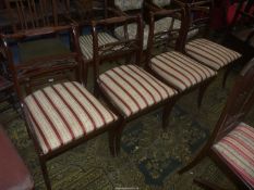 A set of four contemporary sabre legged Dining Chairs with top rails simulating the rope ratlines