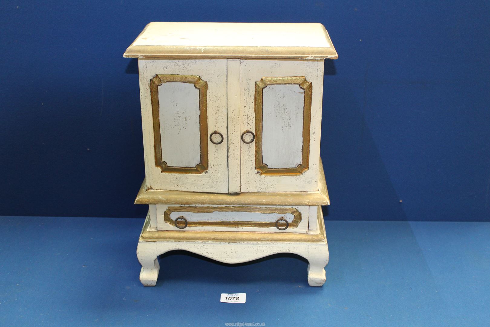 A vintage miniature country made rustic Cabinet comprising base drawer below double panel doors