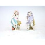 A pair of miniature figures of children,