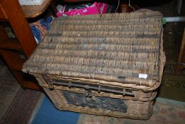 A large Cane Laundry Basket having iron fittings and latching system, 34'' x 24'' x 22 1/2'' high.