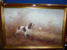 A large Oil on canvas of two liver and white Spaniels standing in long grass, signed (Kingman?),
