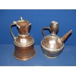 A copper kettle and large copper jug both in middle Eastern design.