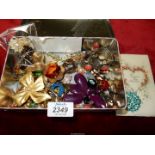 A tin containing costume jewellery including Lucite Brooch "Jelly Belly"