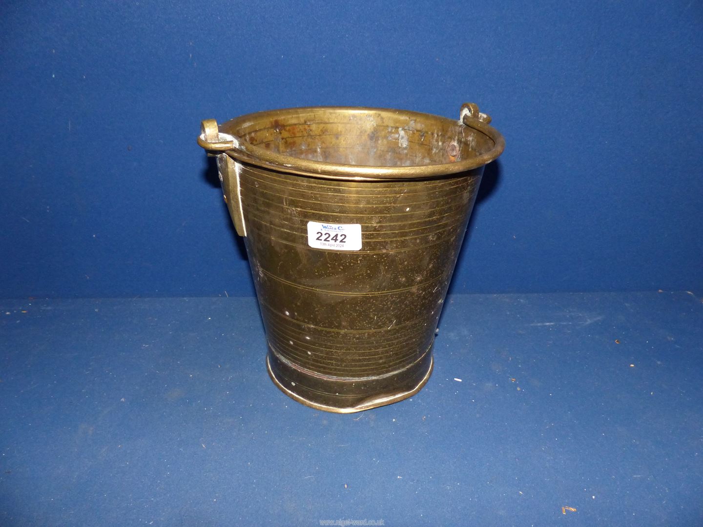 A brass bucket, 9" tall.