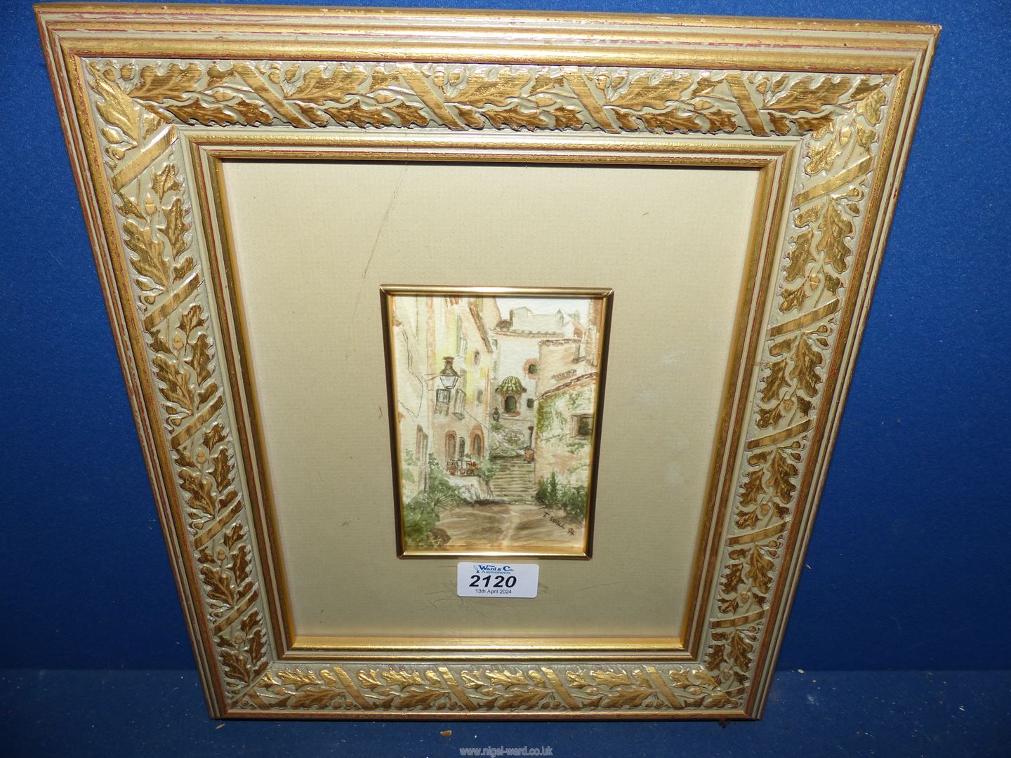 A framed and mounted Watercolour titled verso 'A Quiet Corner of Spain', signed lower right 'T.