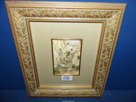 A framed and mounted Watercolour titled verso 'A Quiet Corner of Spain', signed lower right 'T.