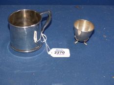 A continental silver egg cup standing on three feet, stamped 830 for Norway,