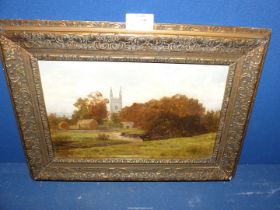 An ornately framed Oil on board depicting a country landscape with hayricks and a church,