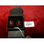 A pair of oval amber mounted in 925 silver clip-on earrings, 1/2" long.