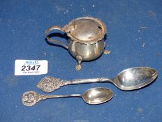 A Silver mustard pot on three pawed feet with blue liner, Birmingham and two teaspoons,